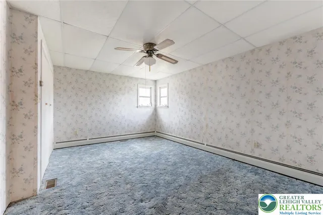 a view of kitchen with refrigerator and wooden floor