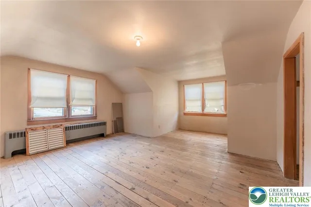 a bathroom with a toilet a sink and a window