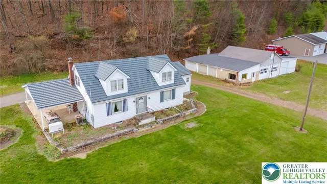 a view of a house with a yard and garden