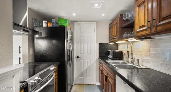 a living room with furniture kitchen view and a window