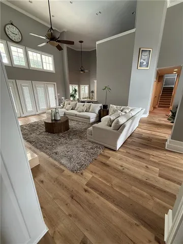 a living room with furniture a flat screen tv and kitchen view