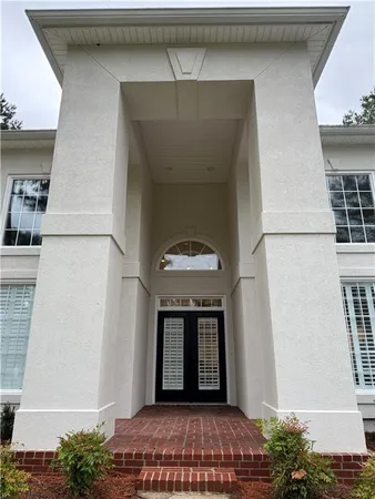a living room with fireplace furniture and a chandelier