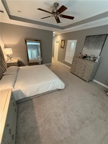 a view of a hallway with furniture and wooden floor