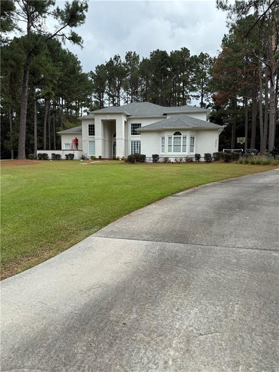 4632 Ridgeview Circle Valdosta, GA 31602 - Photo 3 of 70 a view of a white house with a big yard and large trees
