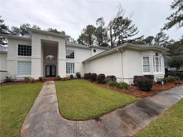 a view of a hallway with entryway and dining room