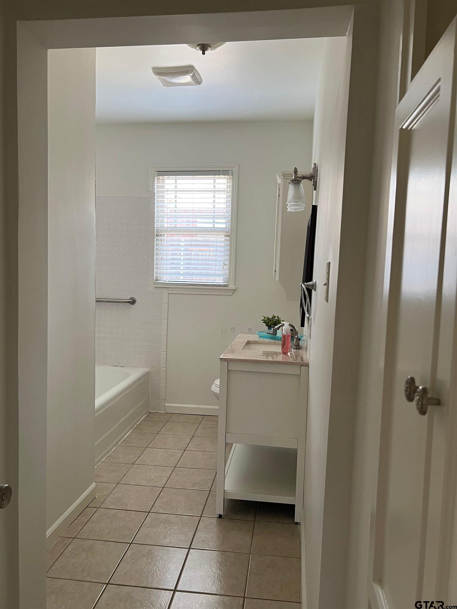 328 Mockingbird Lane Tyler, TX 75701 - Photo 11 of 12 a bathroom with a sink a toilet and shower