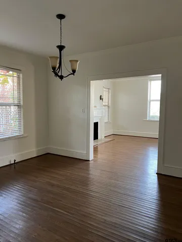 a view of a room with wooden floor and windows