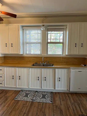 a view of a kitchen with wooden floor