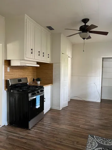a kitchen with granite countertop a stove and a refrigerator