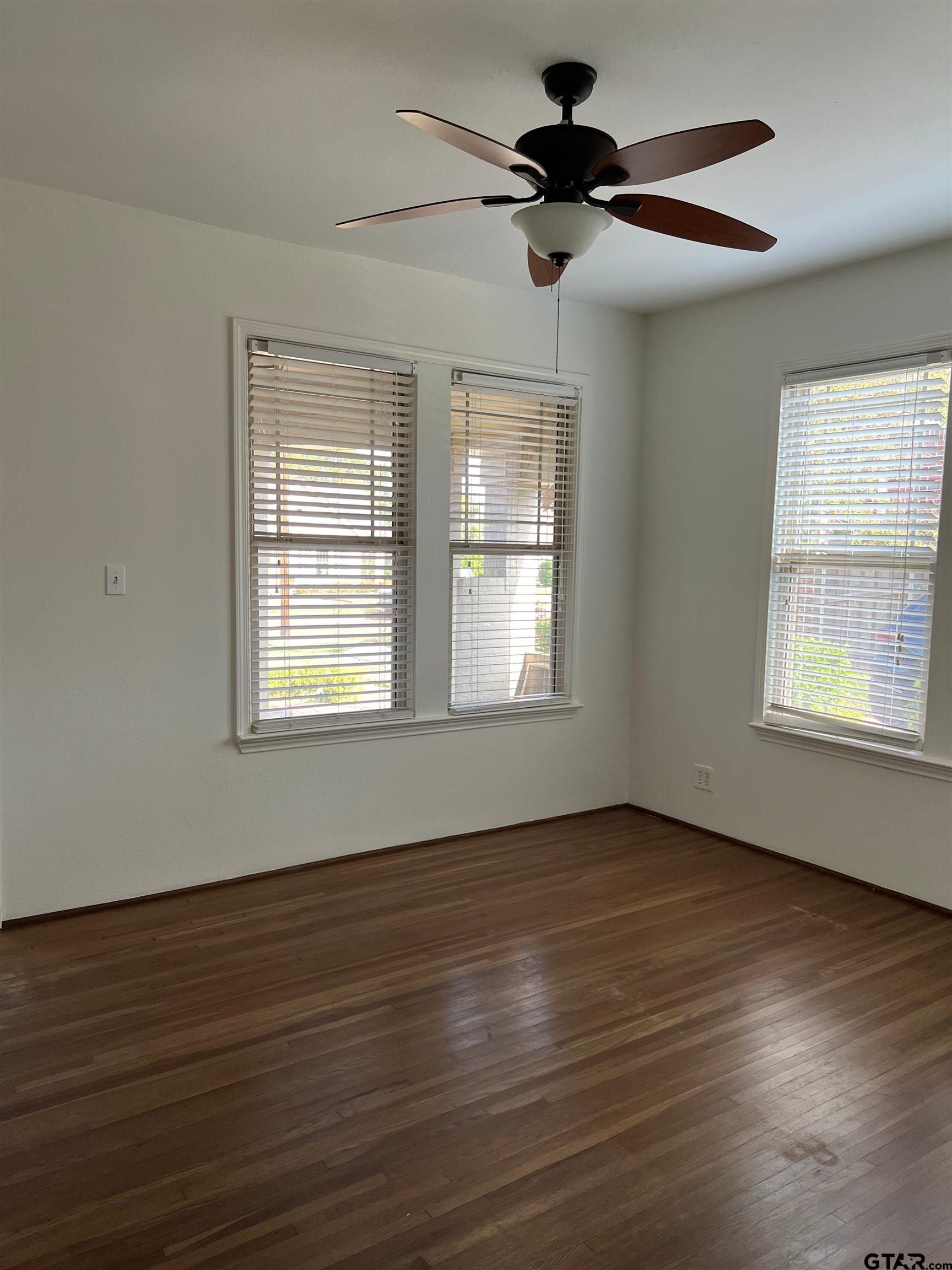 328 Mockingbird Lane Tyler, TX 75701 - Photo 9 of 12 a view of an empty room with wooden floor and a window