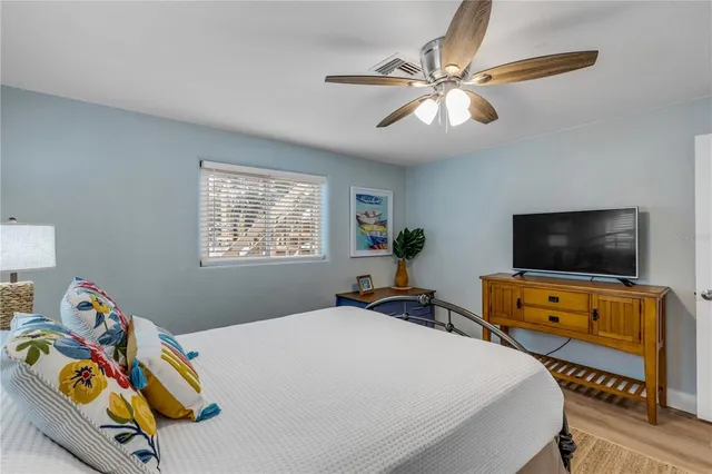 a bathroom with a sink a toilet a mirror and shower