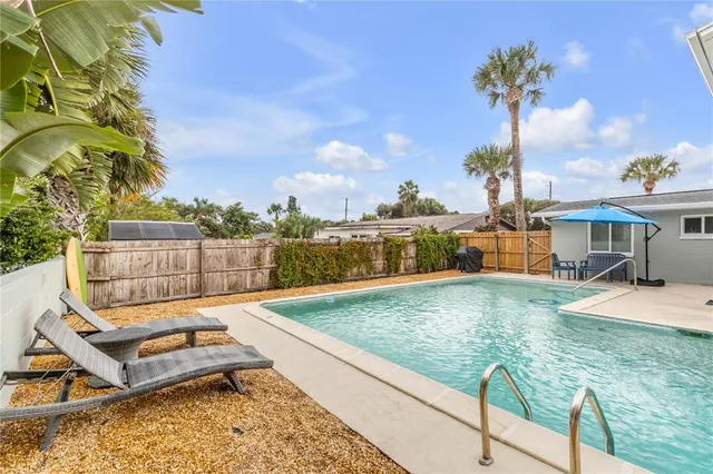 a view of a swimming pool with a patio