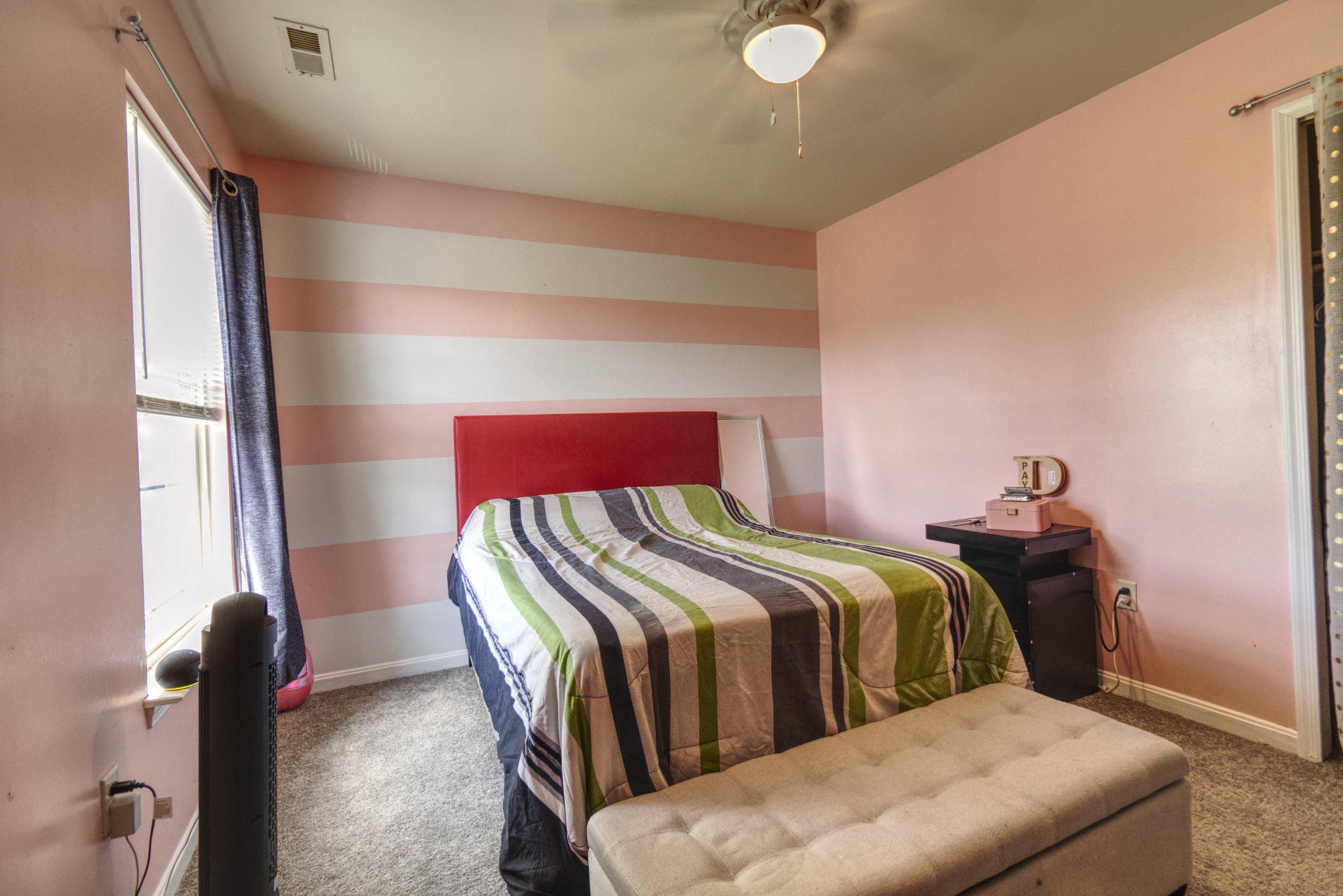215 Seamaster Road Essex, MD 21221 - Photo 25 of 40 a bedroom with a bed and wooden floor
