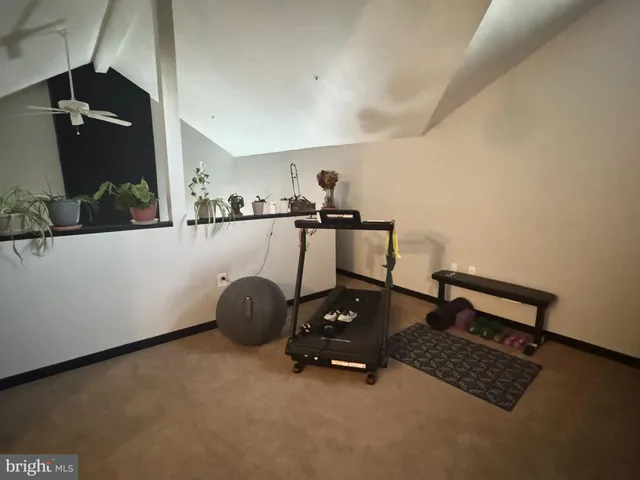 a room with gym equipment and a view of living room
