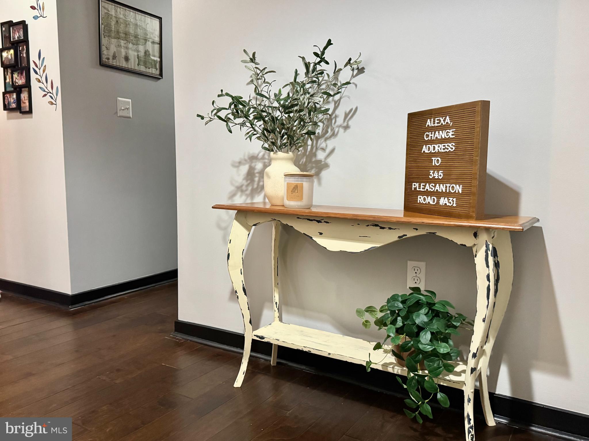 345 Pleasanton Road, Unit A31 Westminster, MD 21157 - Photo 2 of 16 a vase of flowers sitting on a table with a potted plant