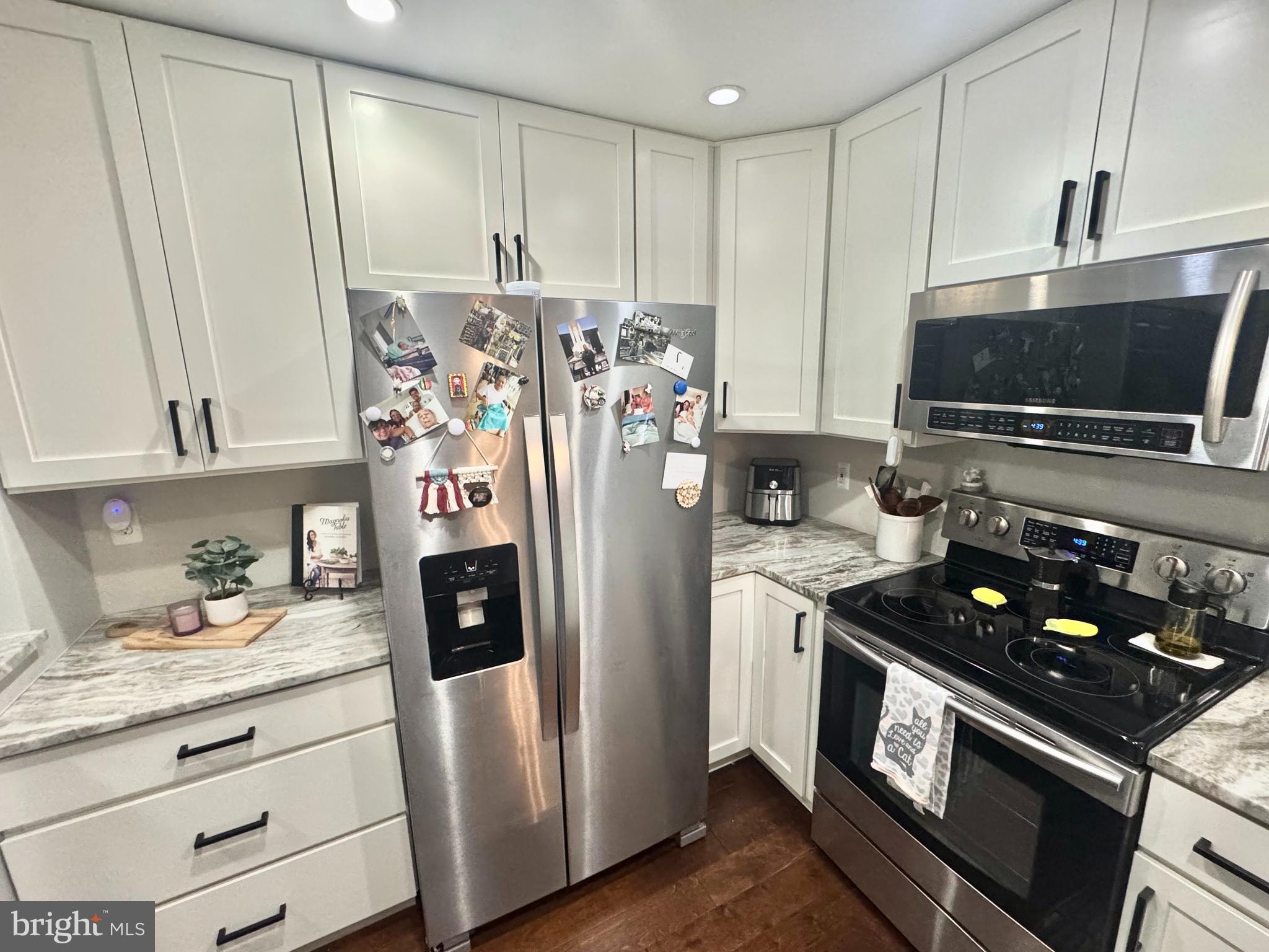 345 Pleasanton Road, Unit A31 Westminster, MD 21157 - Photo 4 of 16 a kitchen with stainless steel appliances granite countertop a refrigerator stove and sink
