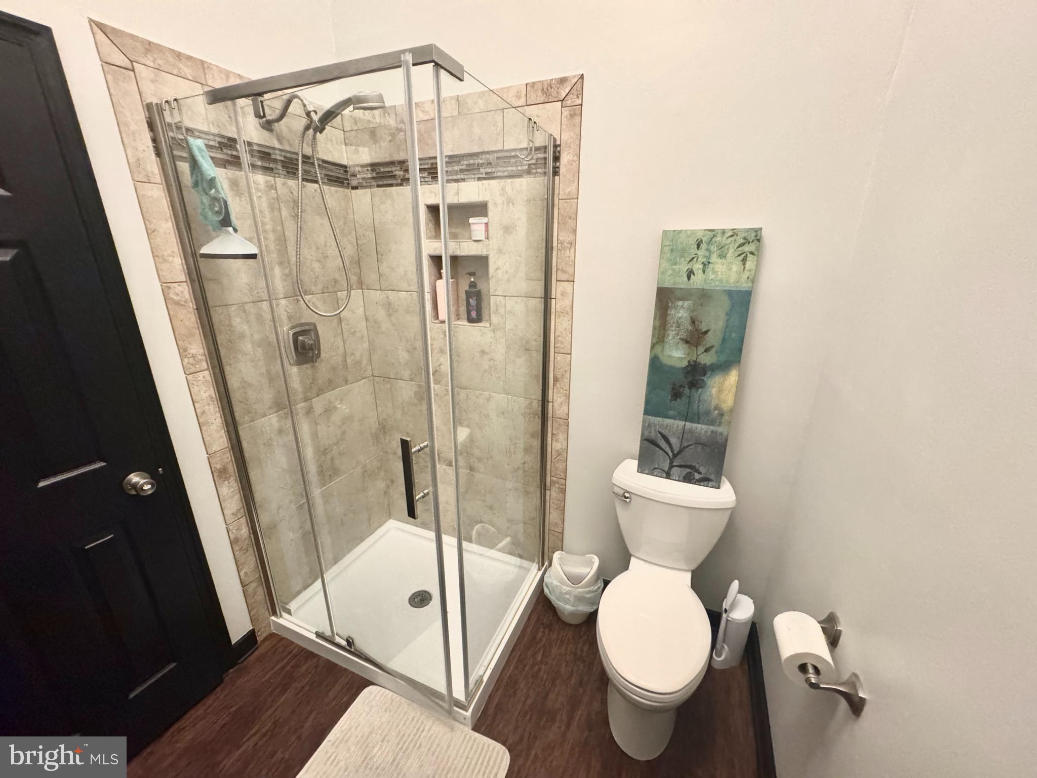 345 Pleasanton Road, Unit A31 Westminster, MD 21157 - Photo 7 of 16 a bathroom with a toilet a sink and shower