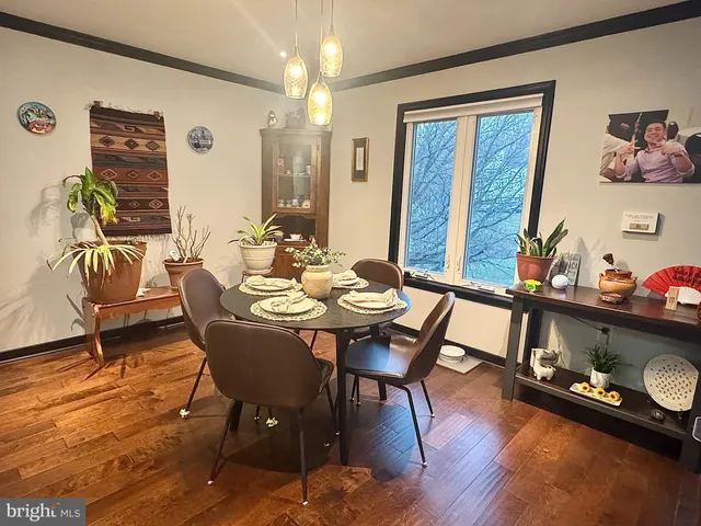 a view of a dining room with furniture wooden floor and chandelier