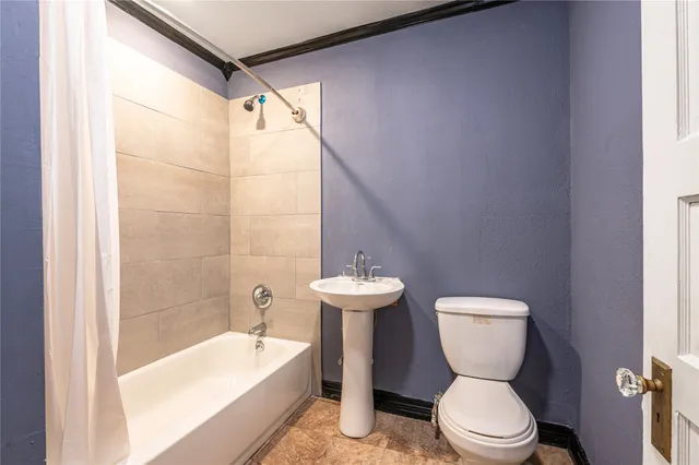 a bathroom with a toilet a sink and bathtub