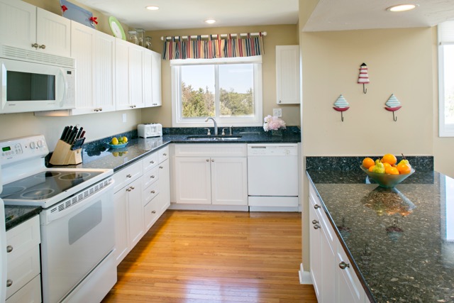 9 Dunes Road Edgartown, MA 02539 - Photo 2 of 12 a kitchen with stainless steel appliances granite countertop a stove a sink and a microwave