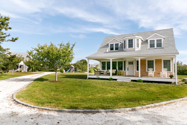 9 Dunes Road Edgartown, MA 02539 - Photo 7 of 12 a front view of a house with a garden and trees