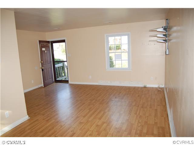 2806 Shiloh Church Road Midlothian, VA 23112 - Photo 4 of 15 a view of an empty room with wooden floor and a window