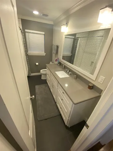 a bathroom with a sink a mirror and a toilet