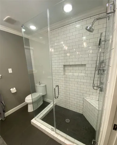 a bathroom with a shower and toilet