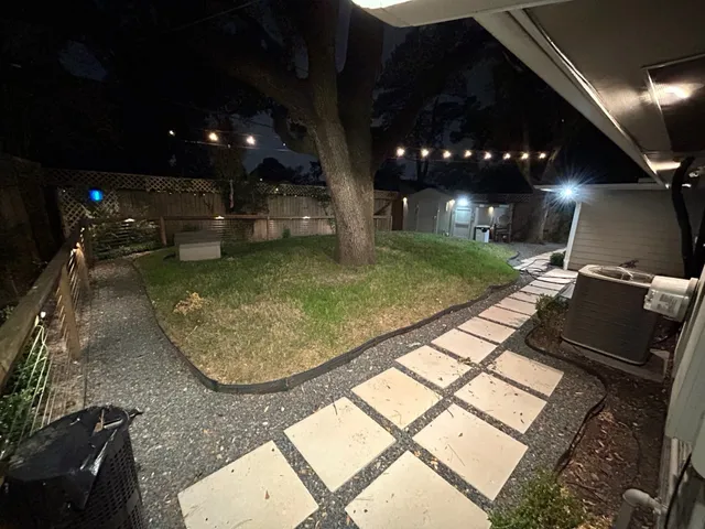 a view of a house with a backyard