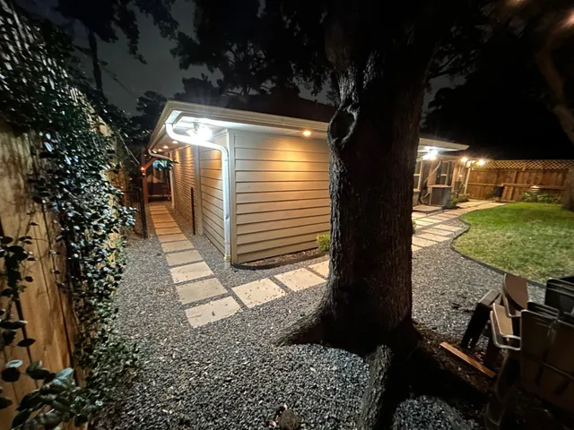 a view of a house with backyard and sitting area