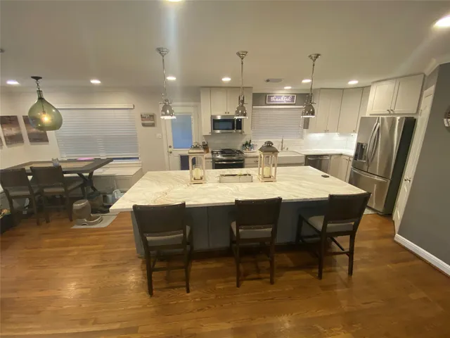 a large kitchen with a table and chairs
