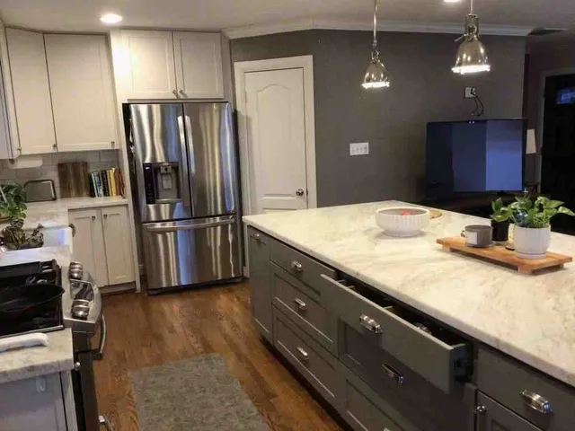 a kitchen with stainless steel appliances granite countertop a refrigerator and a sink