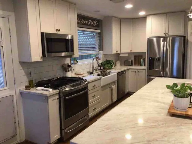 a kitchen with a stove and a refrigerator