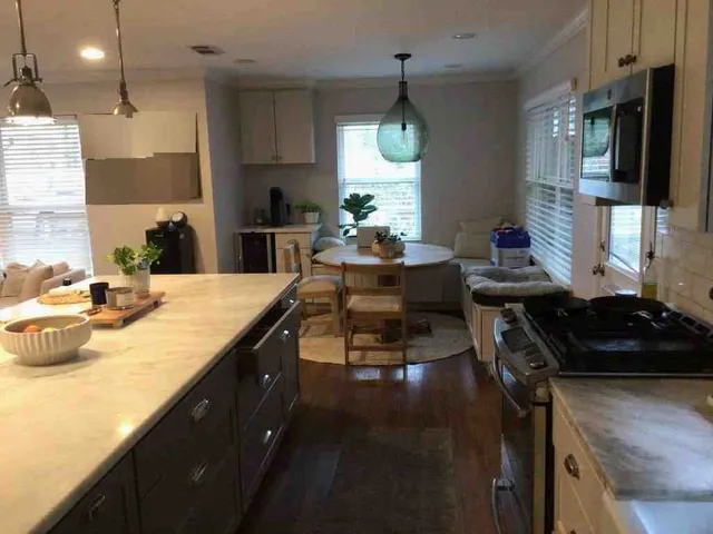 a kitchen with sink stove and cabinets