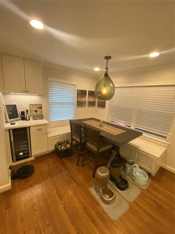 a gym room with wooden floor and furniture