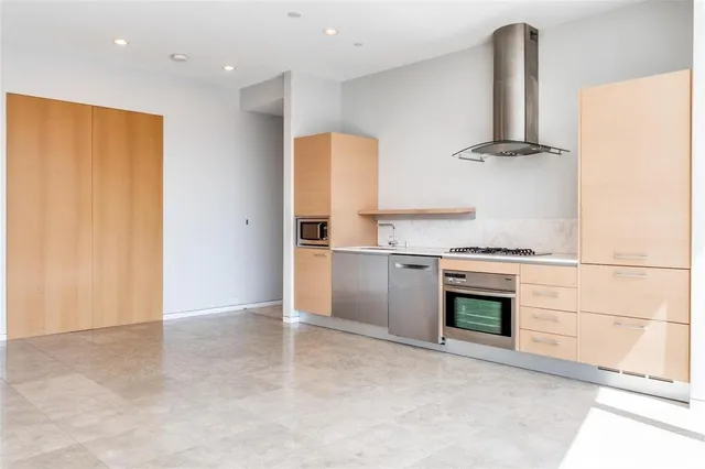 a kitchen with stainless steel appliances a stove and a refrigerator