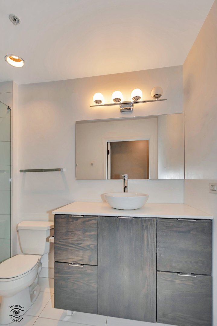 845 North Kingsbury Street, Unit 211 Chicago, IL 60610 - Photo 15 of 26 a bathroom with a sink and a toilet