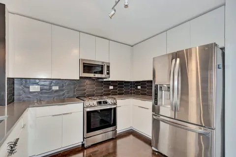 a kitchen with a refrigerator stove and microwave
