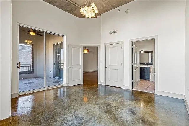 wooden floor with a chandelier