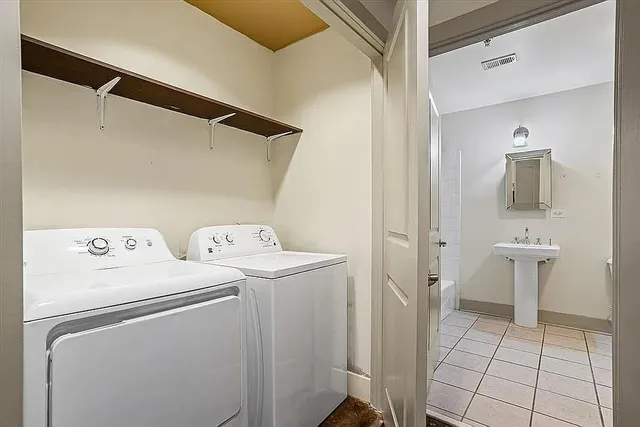 a view of bathroom with a washer and dryer