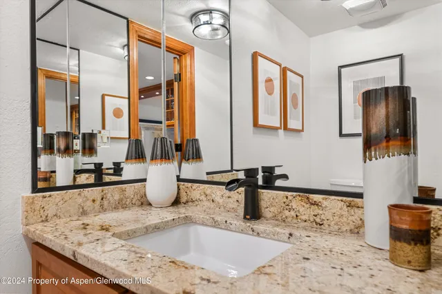 a kitchen with granite countertop a sink and a window
