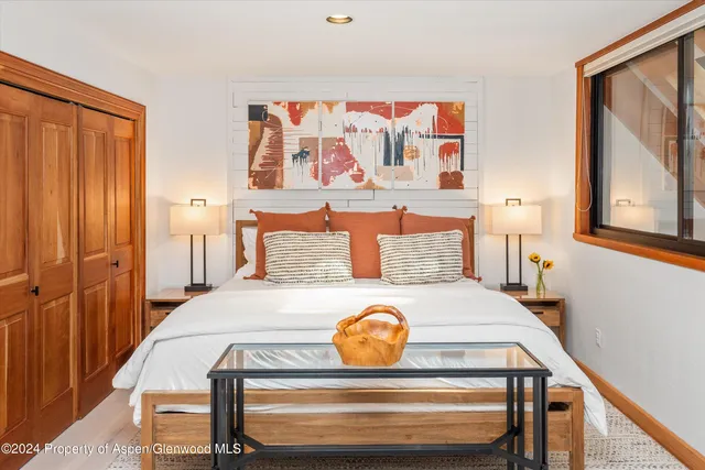 a view of a bedroom with furniture and wooden floor