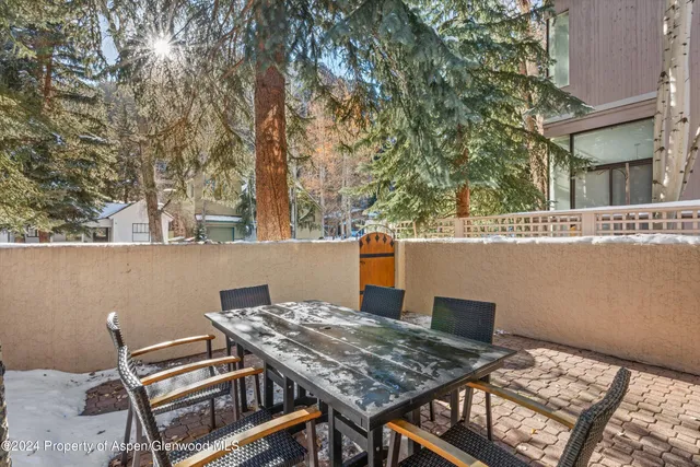 a view of a chairs and table in a patio