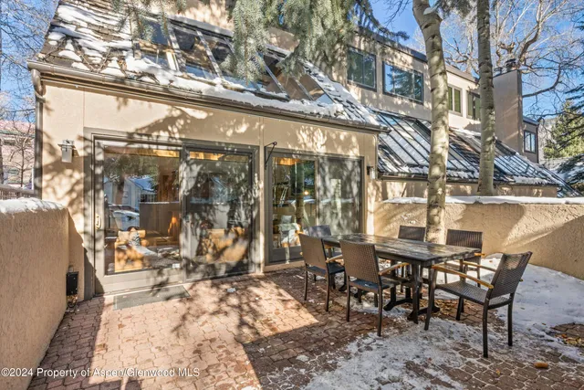 a backyard of a house with large trees