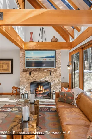 a living room with furniture a fireplace and a table