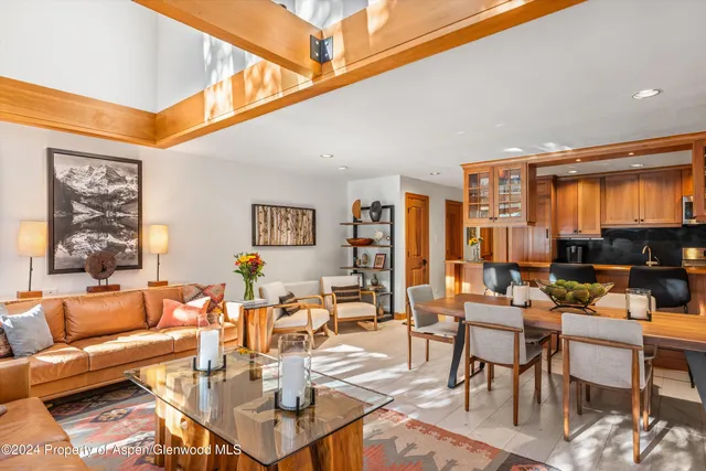 a living room with furniture a rug and a window
