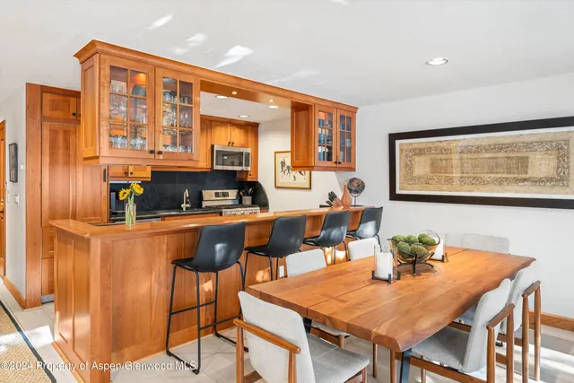 a view of a dining room with furniture and chandelier