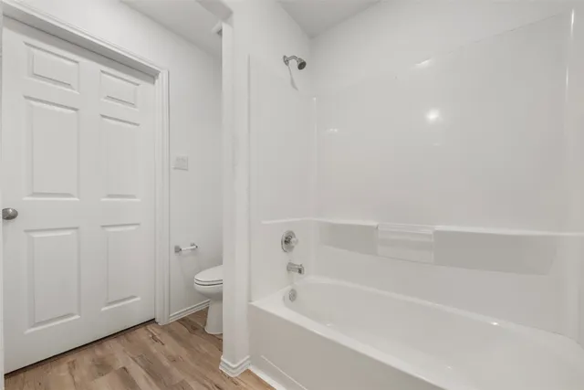 a bathroom with a bathtub and a toilet