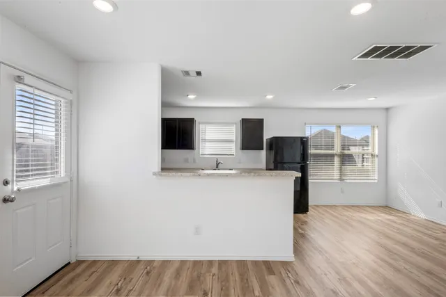 a view of kitchen with wooden floor and window
