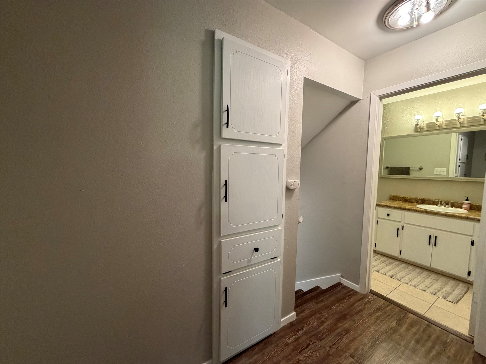 1400 Vista Ridge Cove, Unit B Austin, TX 78754 - Photo 17 of 25 Functional hallway storage adjoins a well-appointed bathroom with a spacious vanity.